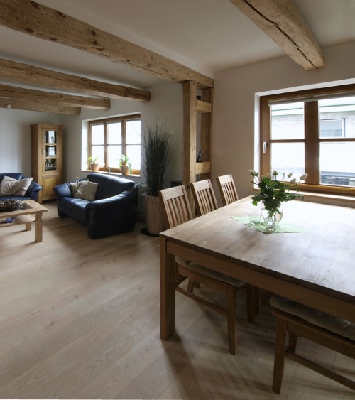 A room with a dining table and sofa