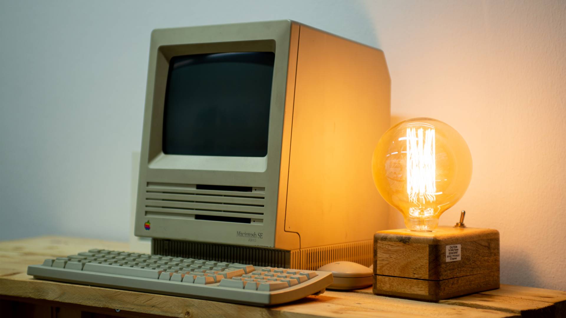 An old computer with a glowing light bulb