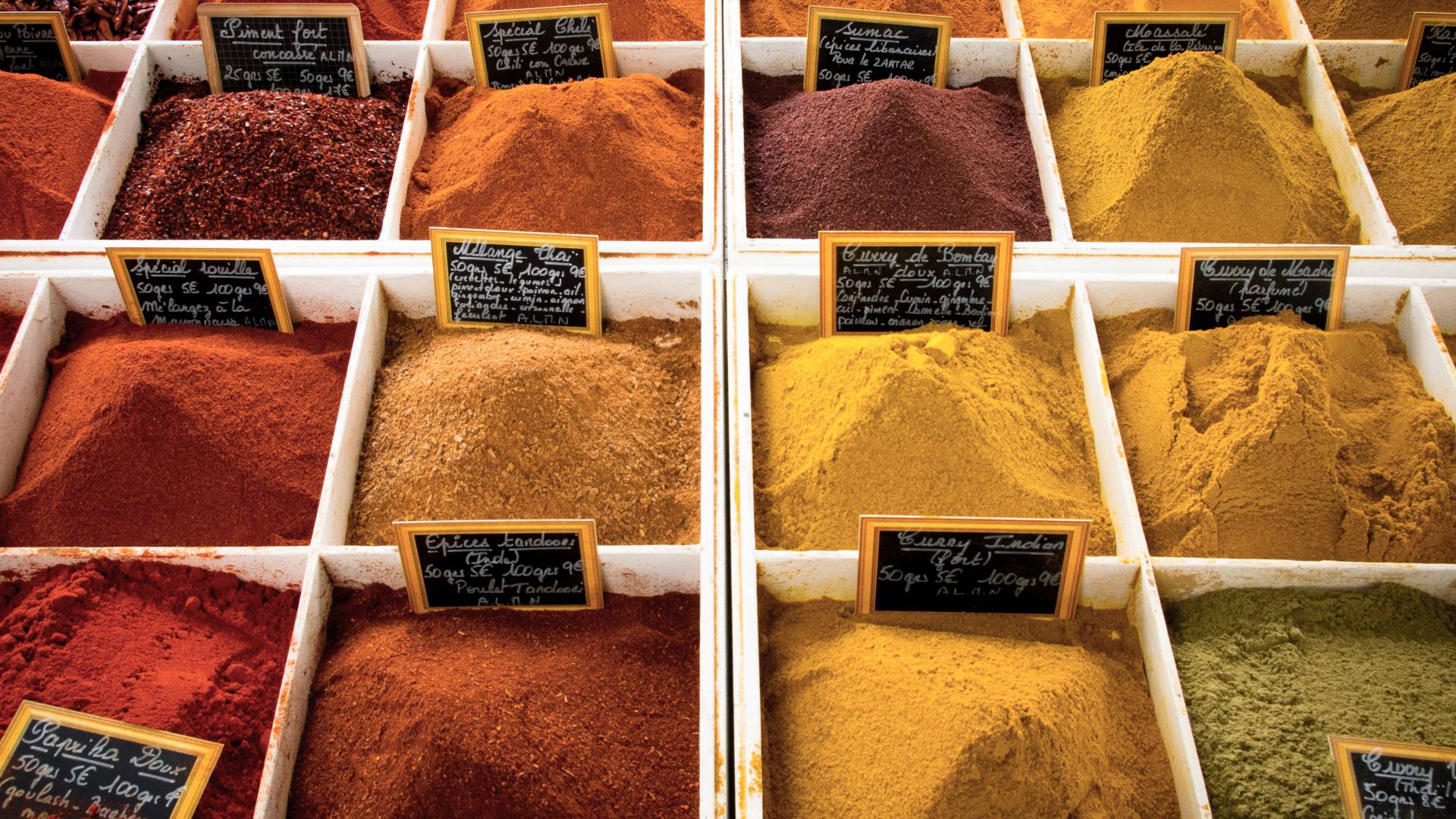 Different spices in wooden boxes