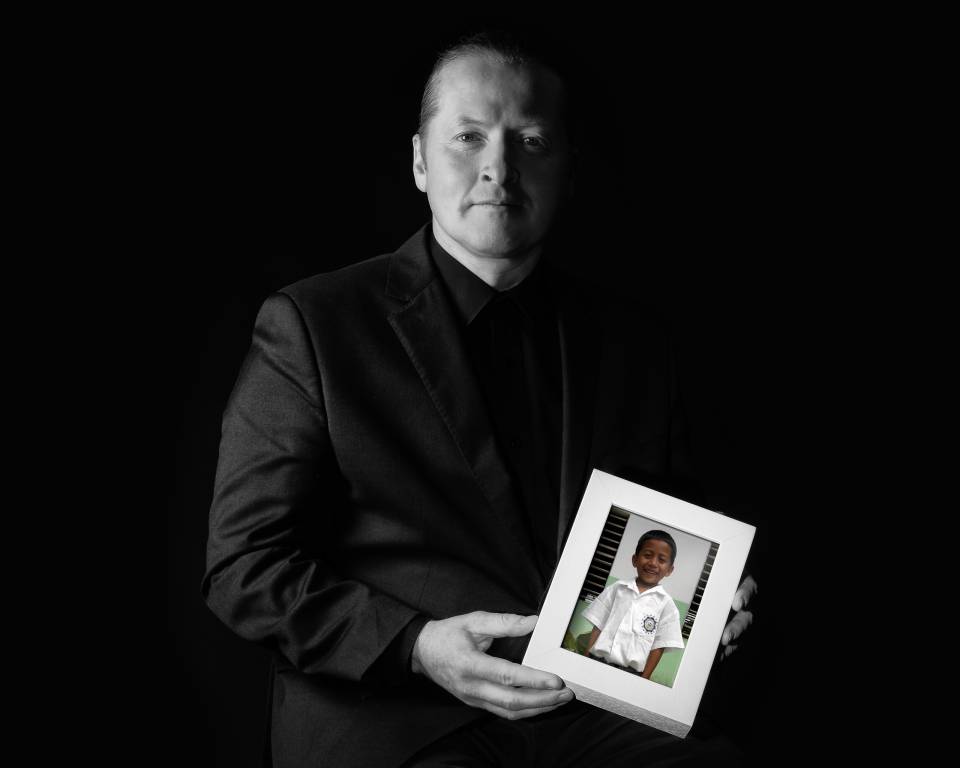 Joey Kelly with a portrait of his sponsored child